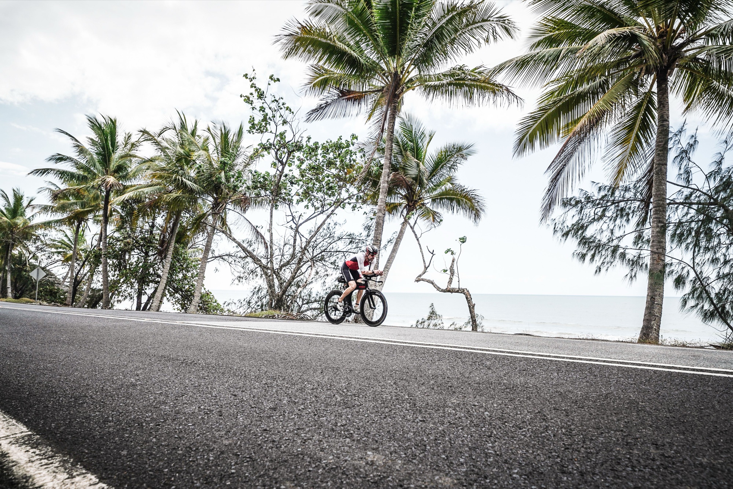 Leighton Wells racing on the coastal road at Ironman Cairns